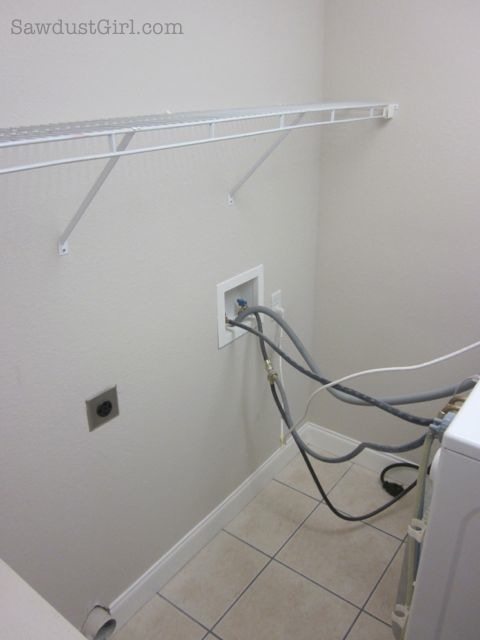 Platform base for large upper cabinet above a washer and dryer