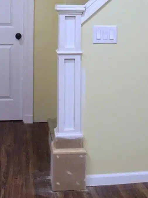 How to Build a Newel Post: DIY Stair Detail 3 Partially built newel post with primed trim and stacked MDF base before painting