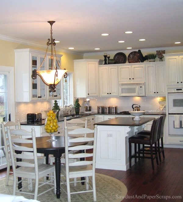 Kitchen with white cabinets and black granite countertops ...