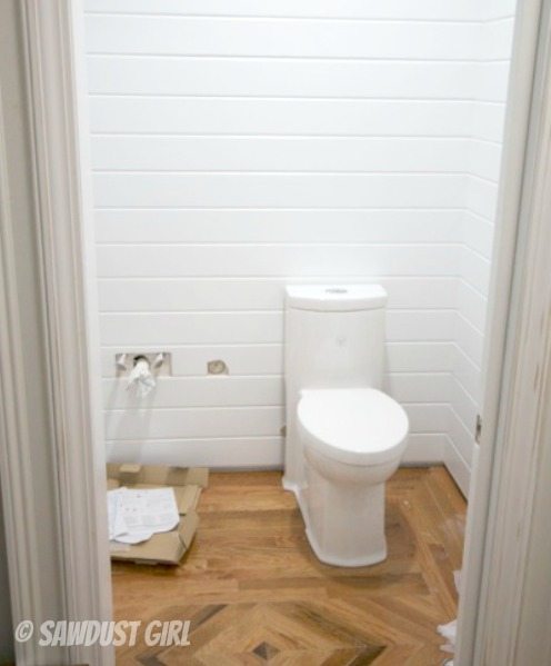 Installing a one piece, skirted toilet.