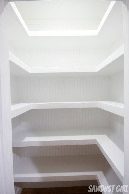 The bottom two shelves are 14″ deep and only cover two walls leaving 