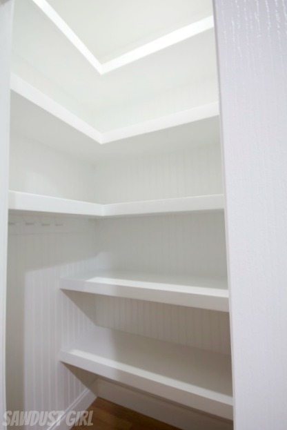 Hall closet with floating shelves