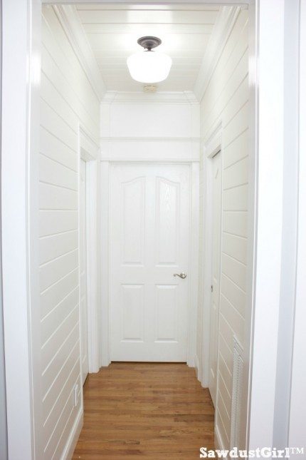 Hallway trim moulding and white plank walls
