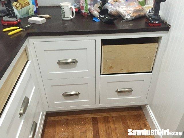 Installing drawer fronts on white cabinets with wood countertop