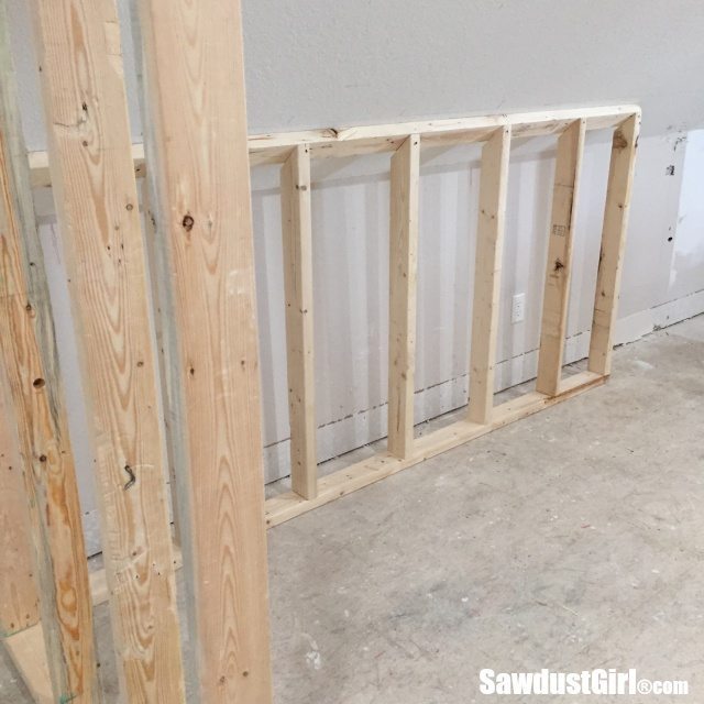 Building a wall behind cabinets to position them correctly in the room.
