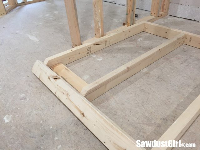 Building a wall behind cabinets to position them correctly in the room.