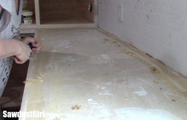 Scraping glue from countertops.