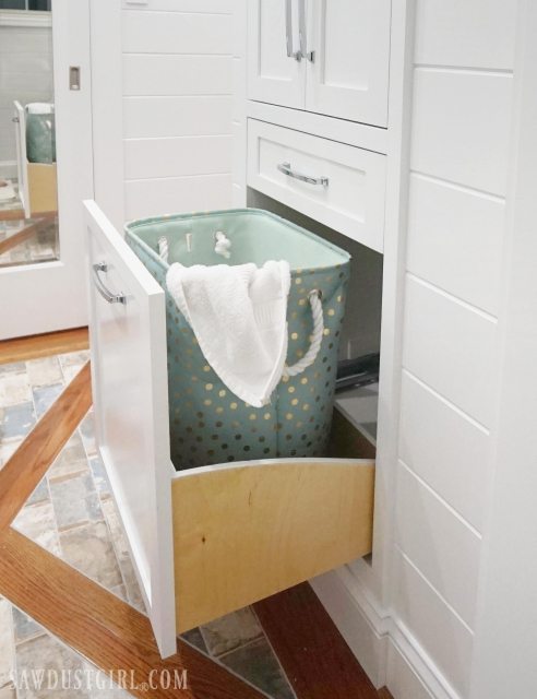 Bathroom linen closet with pull out hamper