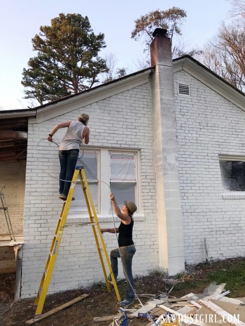 Painting a brick house with an airless sprayer