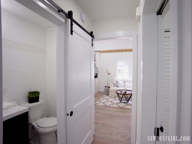 hallway and bathroom with barn door