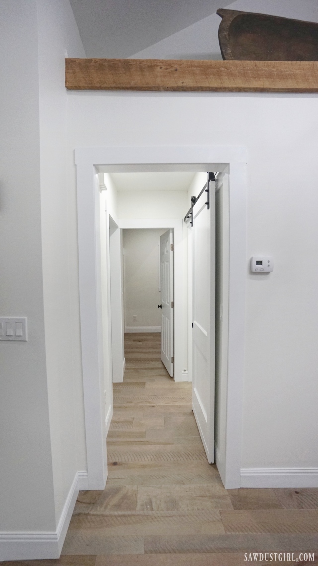 hallway with barn door and exposed beam