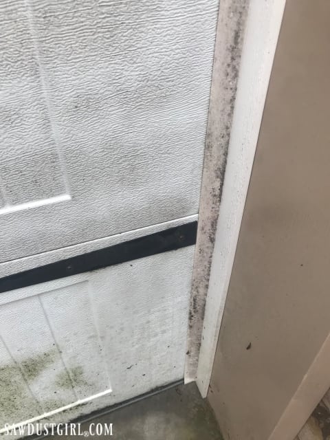 Clean weather stripping around a garage door 