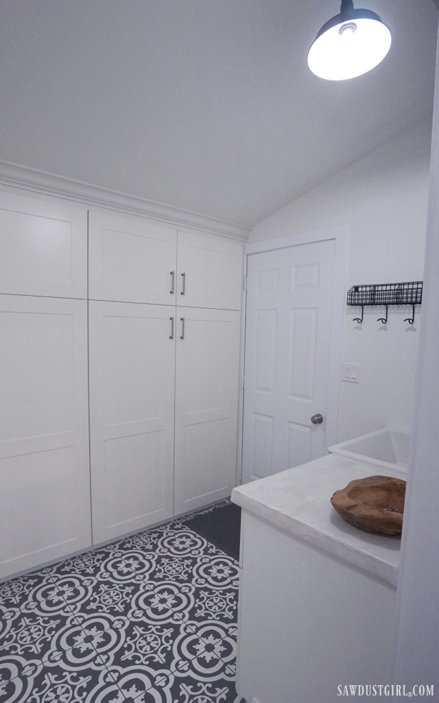 laundry room, black and white tile floor, white cabinets