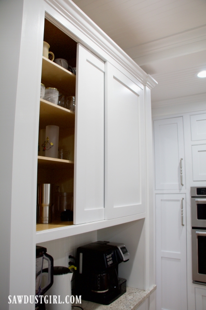 Sliding doors to hide cups and glasses in coffee bar cabinet