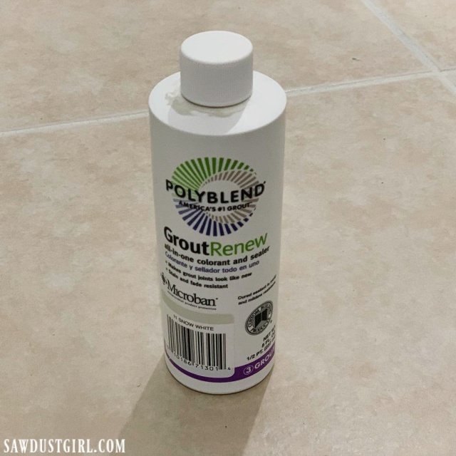 a bottle of grout renew on a tile floor that just had the grout color changed with grout paint