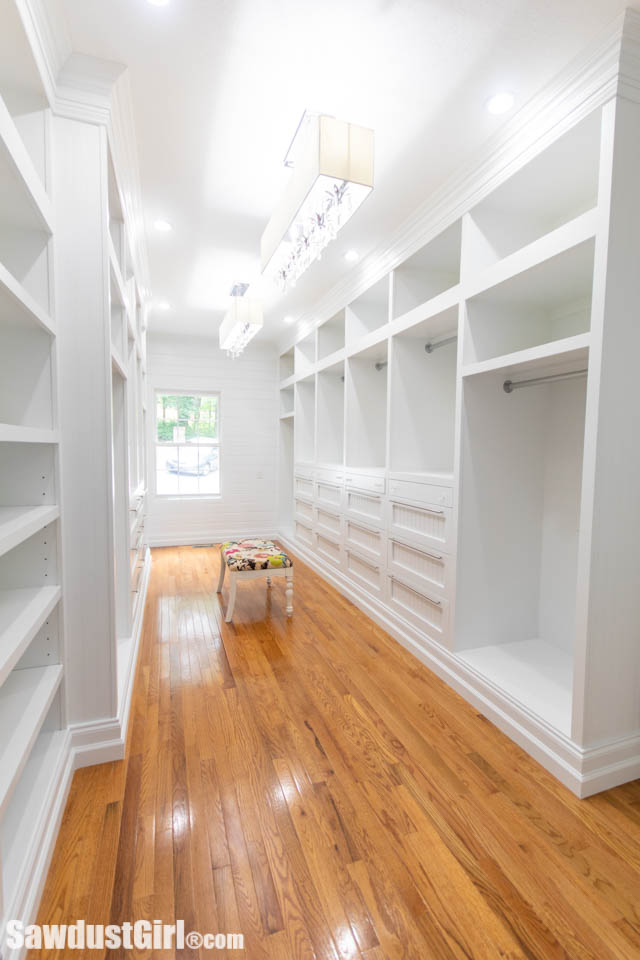 Large walk-in coset with white, custom cabinetry